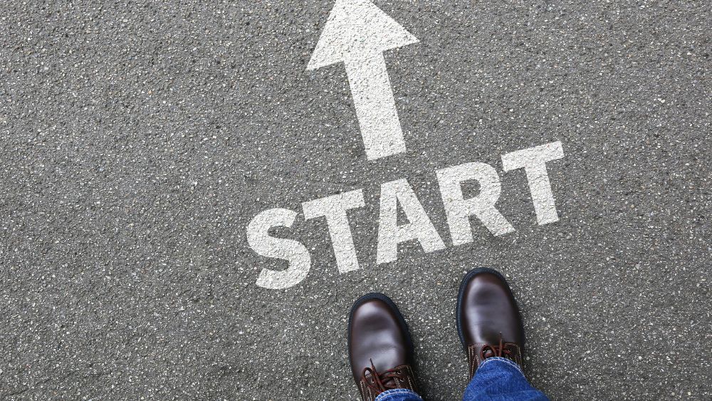 Two feet standing at the beginning of a starting line.